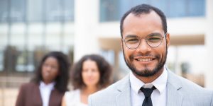 man-smiling-after-tailoring-his-resume-for-a-leadership-role-and-landing-a-leadership-position.jpg