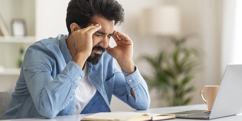 stressed-man-on-laptop-upset-that-he-s-been-laid-off-multiple-times.jpg